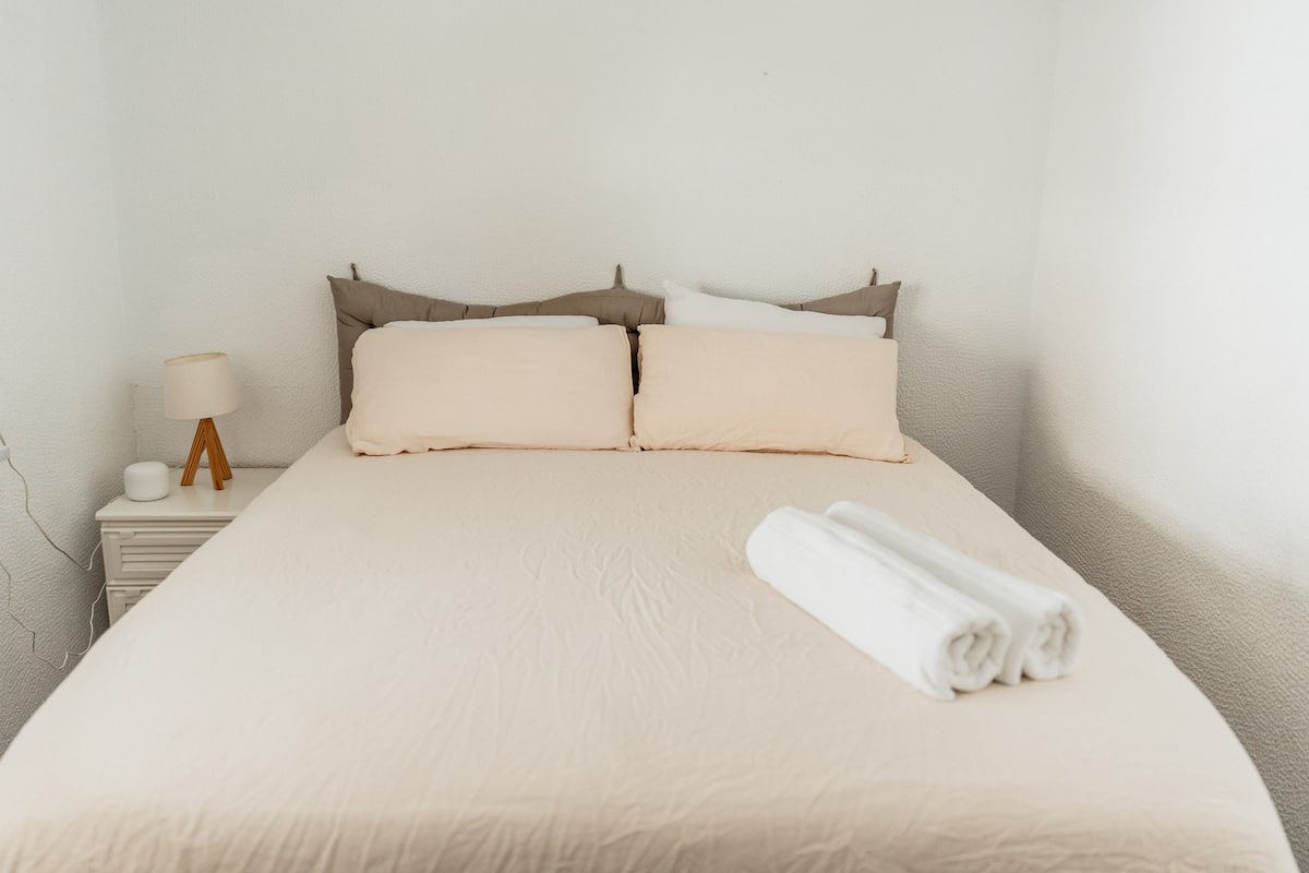 One of the six bedrooms, with a double bed and bedside lamp